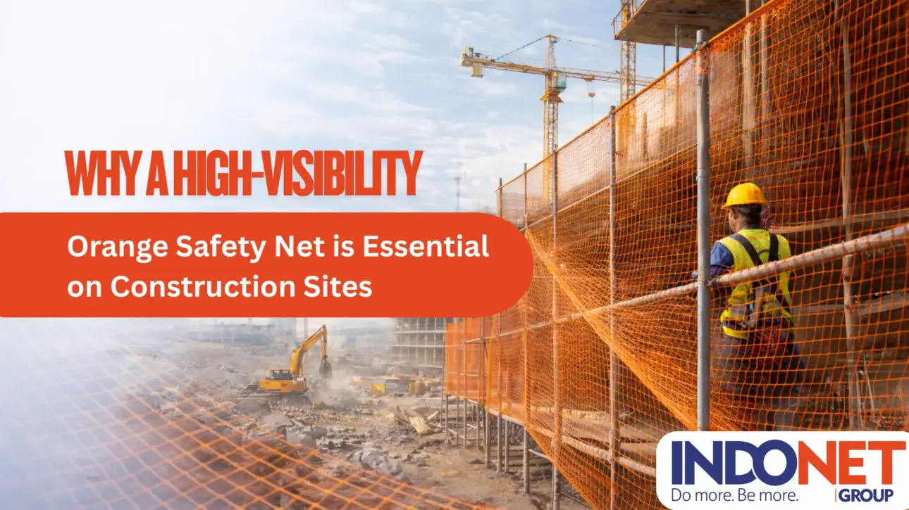 High-visibility orange safety net installed on a construction site for worker safety and debris protection