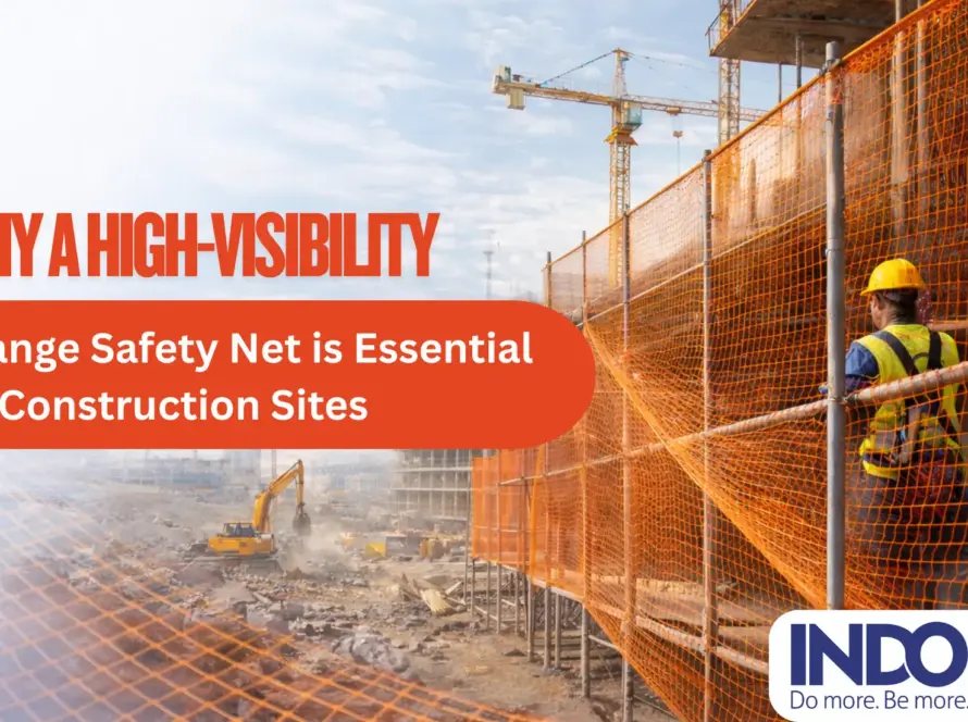 High-visibility orange safety net installed on a construction site for worker safety and debris protection