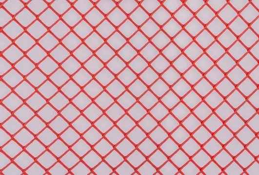 Red diamond-patterned protection mesh and tape used for fencing or safety applications, displayed on a white background.