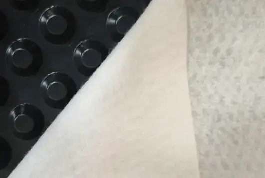 Dimple board with geotextile manufactured for enhanced drainage and filtration