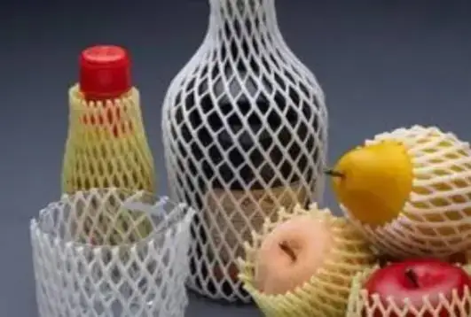 protective foam net sleeves cushioning a glass bottle, a tumbler, and fresh fruits
