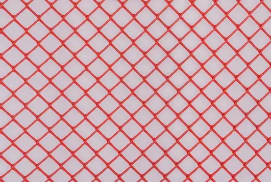 Red protection mesh and warning tape for construction sites, ensuring worker safety and hazard marking by Indonet Group